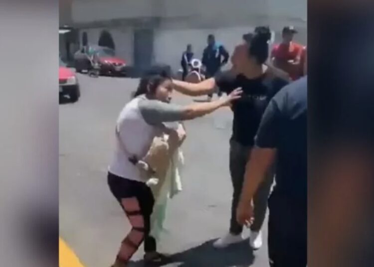 VIDEO: Golpean a mujer con bebé en brazos y a su hija afuera de una secundaria